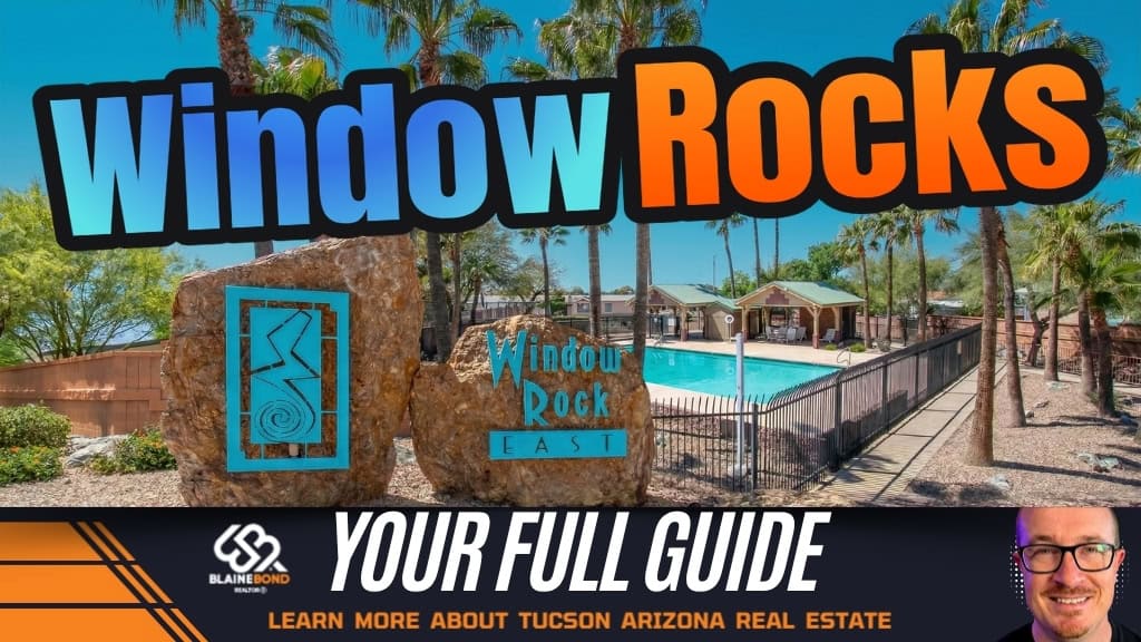 Window Rock East entrance monument beside the community pool and clubhouse framed by tall palm trees in Tucson, Arizona.